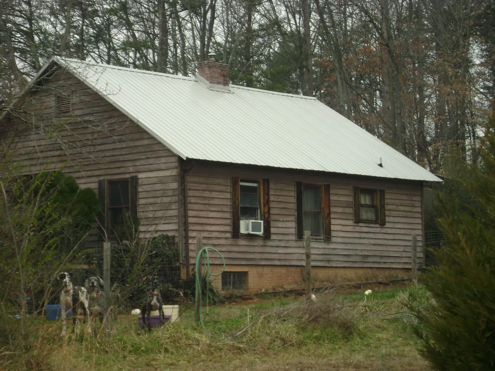 White metal roof on an old wood sided farmhouse, from a Metal Roof Installation job in South Vienna